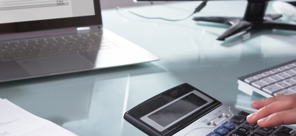 Businessperson Calculating Invoice