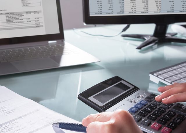 Businessperson Calculating Invoice