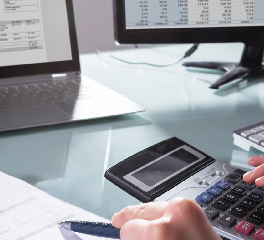 Businessperson Calculating Invoice
