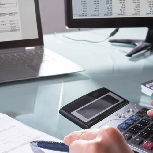 Businessperson Calculating Invoice